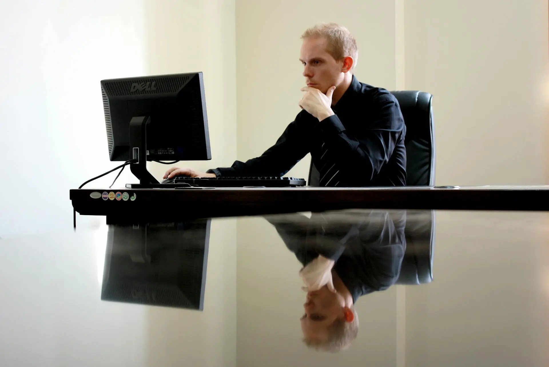 guy searching how to choose a real estate app development company sitting in front of desk